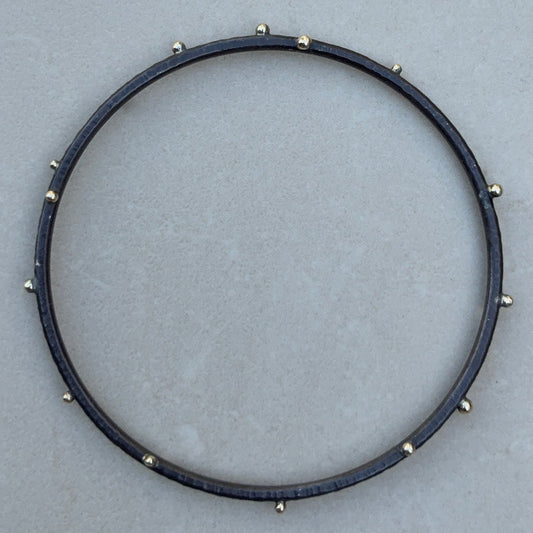 Oxidized and hammer textured siler bangle with gold beads 